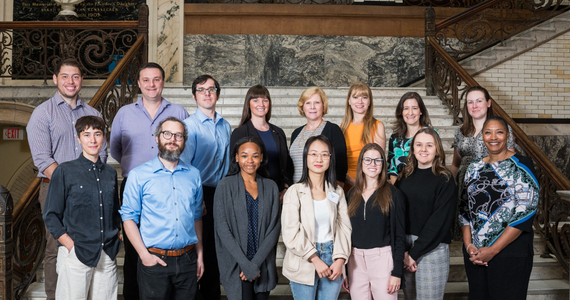Group photo of graduate student fellows and faculty on Main Building stairwell at Drexel